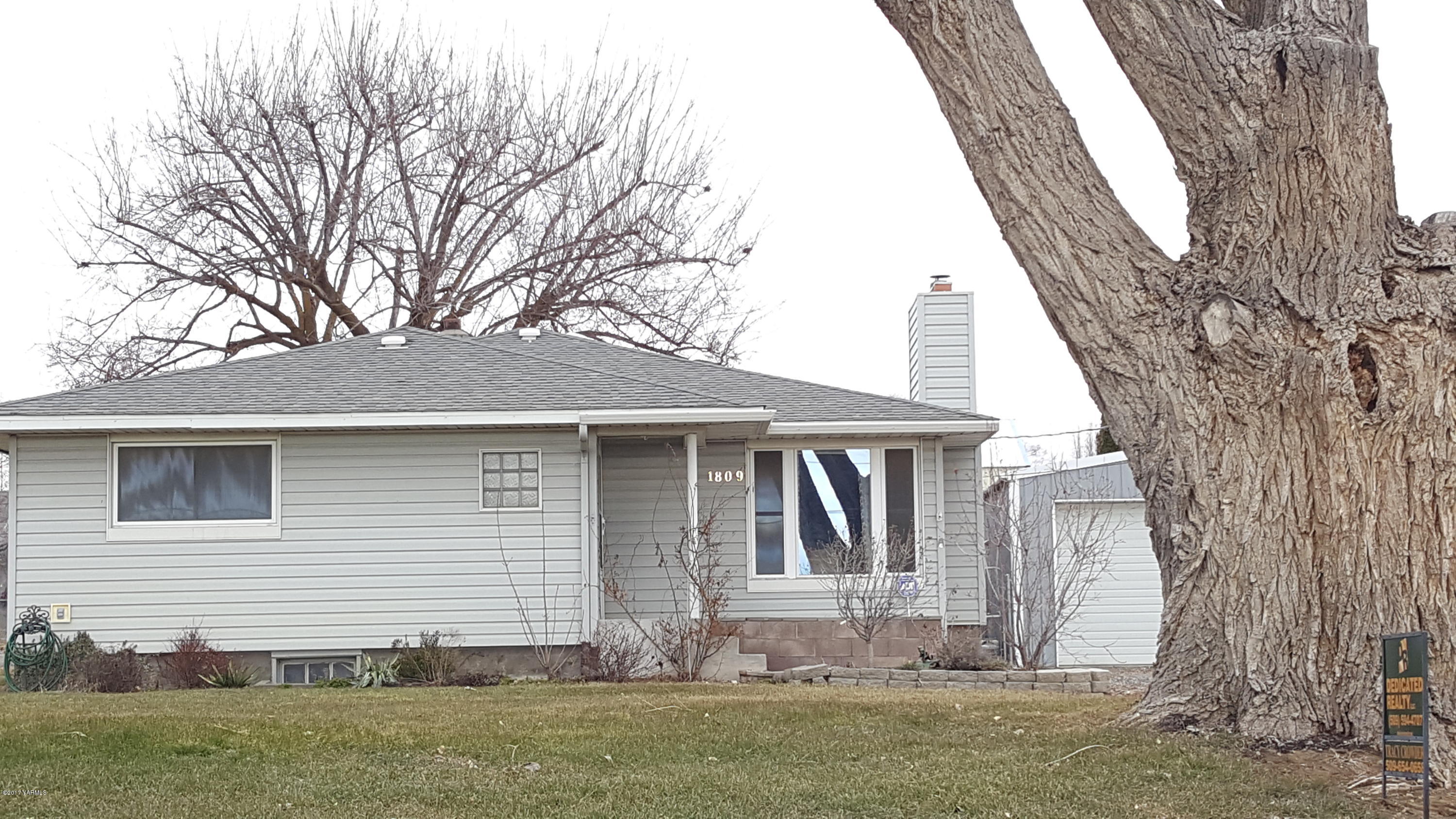 1809 Ekelman Road Yakima, WA 98901 - Photo 2 of 15 a front view of a house with a yard