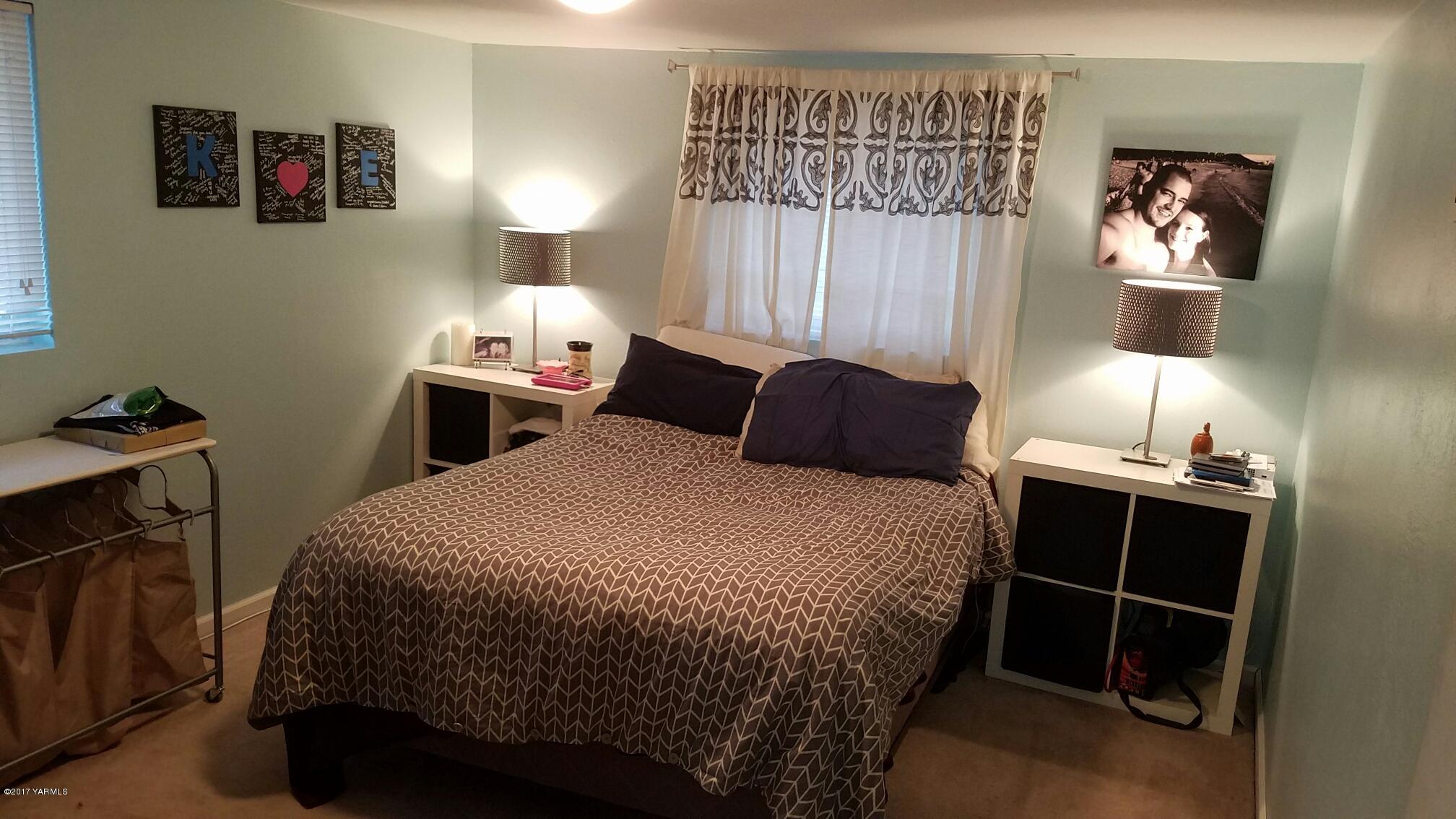 1809 Ekelman Road Yakima, WA 98901 - Photo 11 of 15 a bedroom with a bed and a lamp on dresser