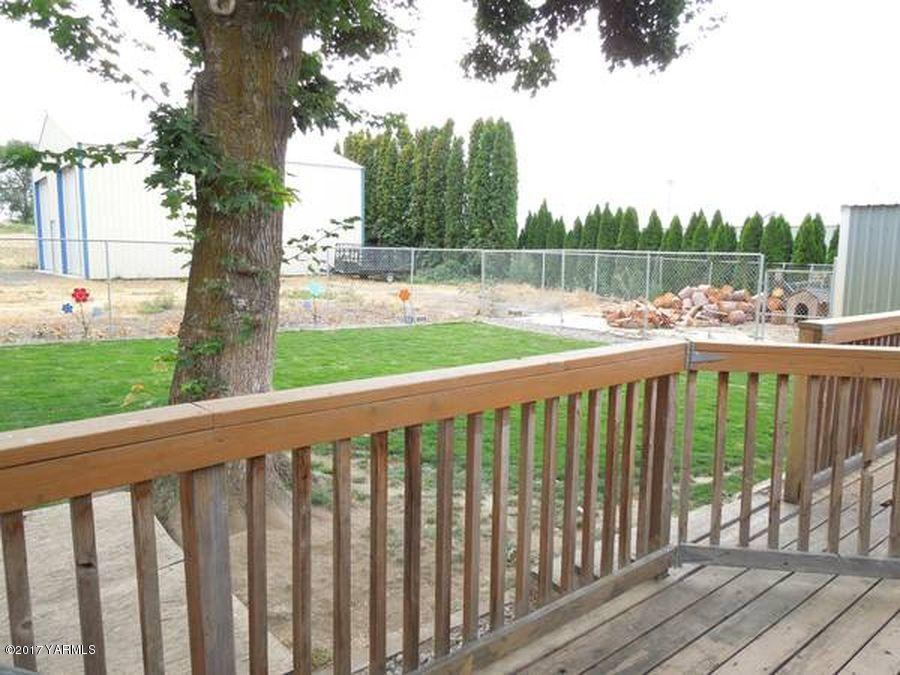 1809 Ekelman Road Yakima, WA 98901 - Photo 13 of 15 a view of a deck with a big yard and large trees