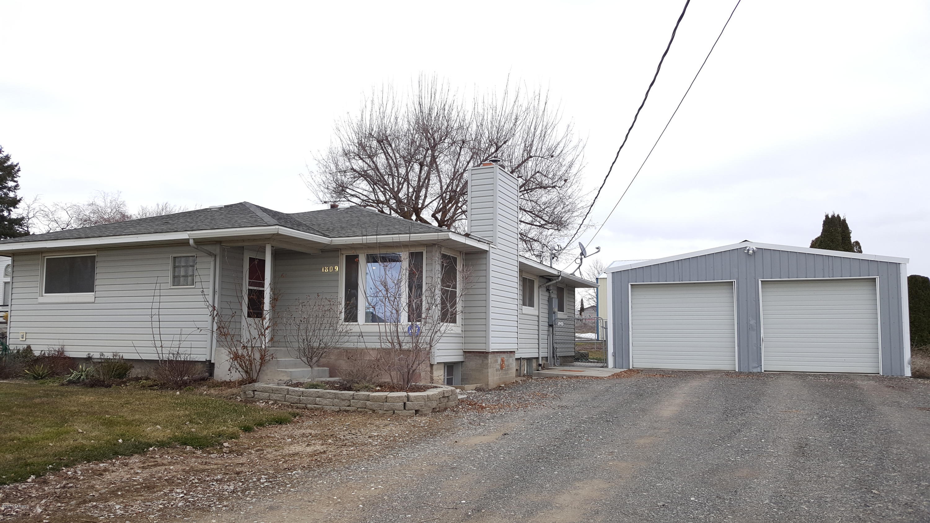 1809 Ekelman Road Yakima, WA 98901 - Photo 3 of 15 a front view of a house with a yard and garage