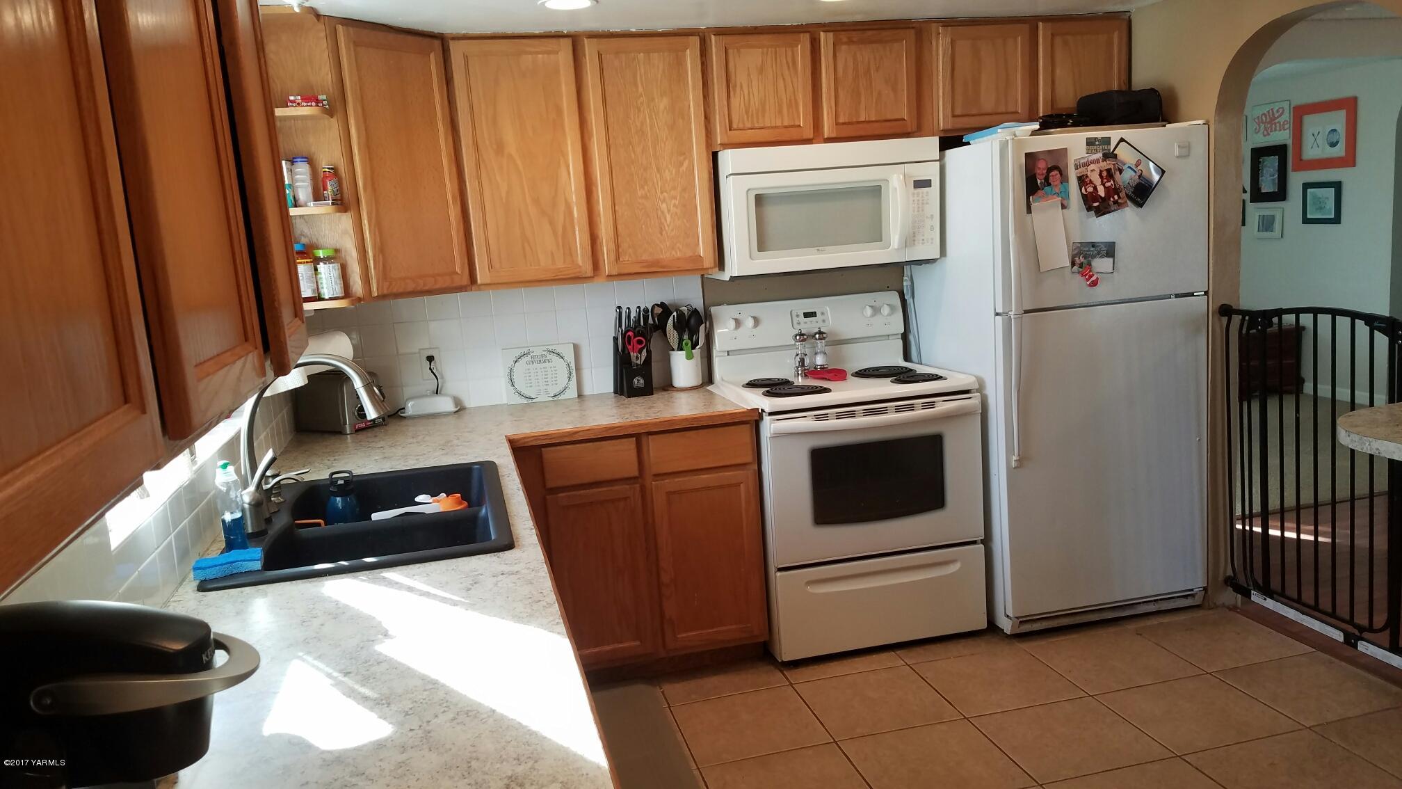 1809 Ekelman Road Yakima, WA 98901 - Photo 6 of 15 a kitchen with a sink a stove and cabinets