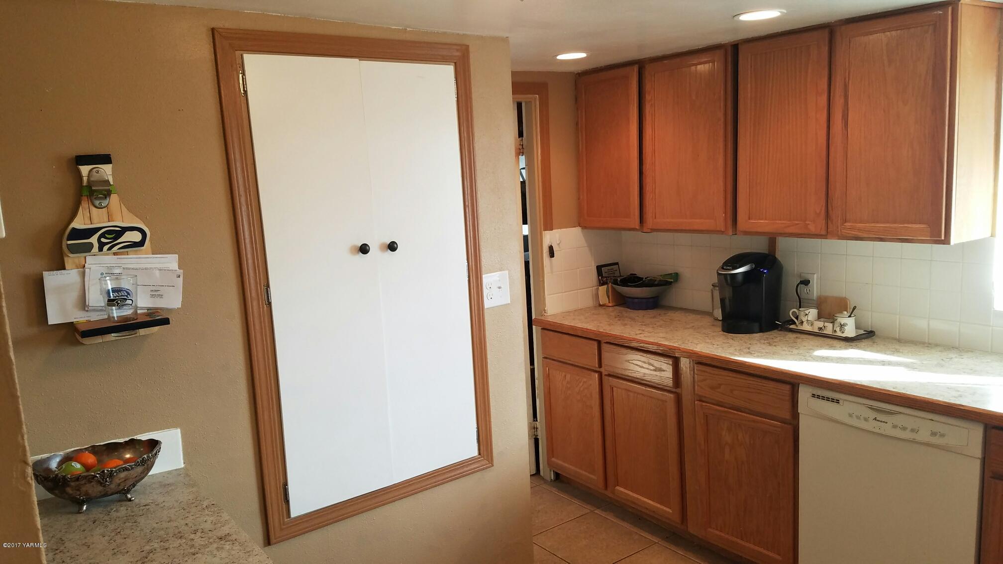 1809 Ekelman Road Yakima, WA 98901 - Photo 7 of 15 a kitchen with a refrigerator and cabinets
