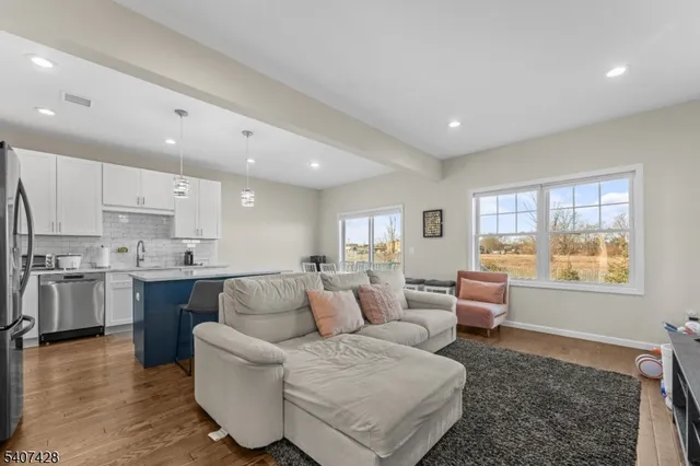a living room with kitchen island furniture and a large window