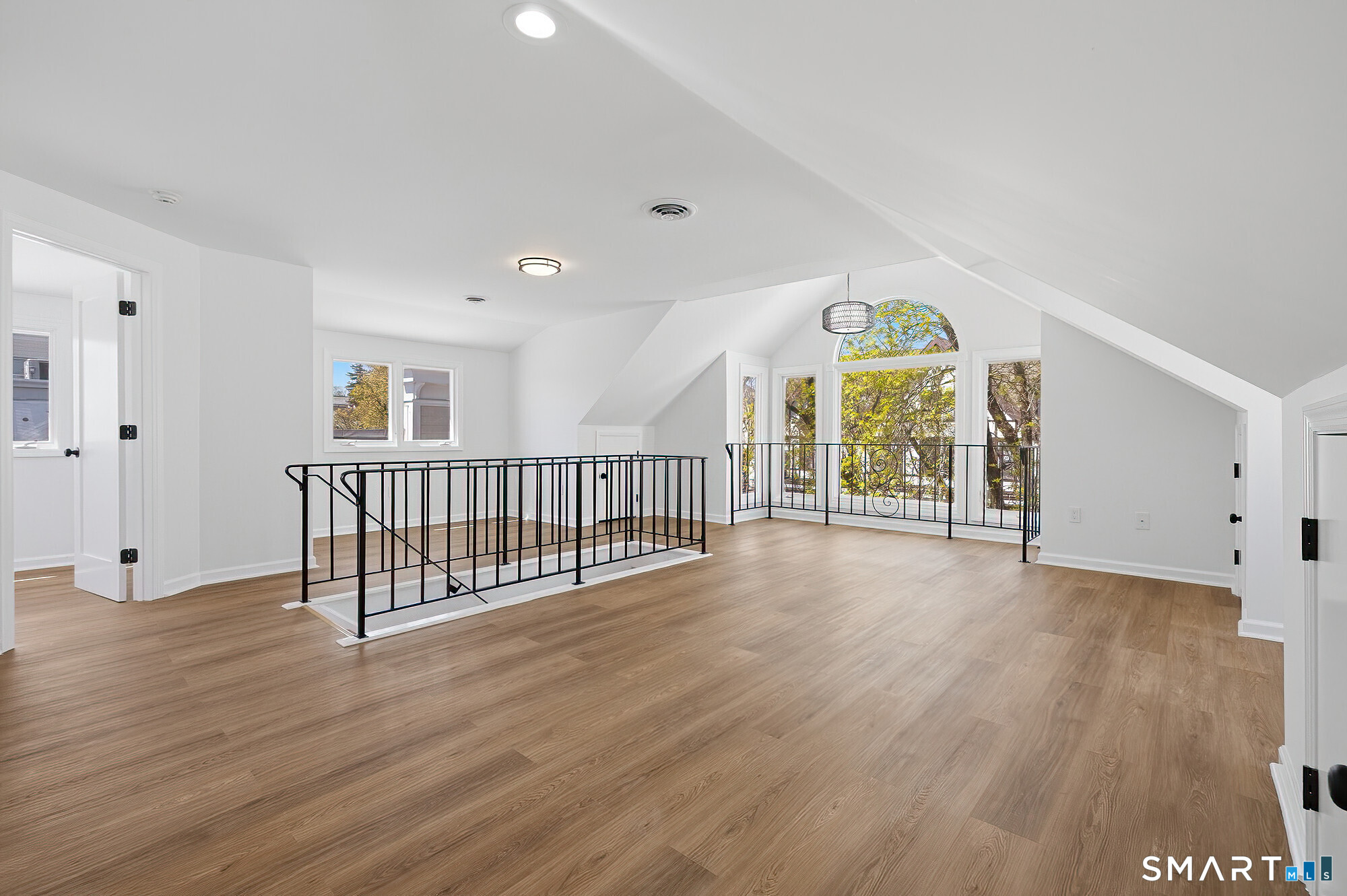 426 Main Street, Unit G Ridgefield, CT 06877 - Photo 2 of 24 wooden floor with a window in an empty room