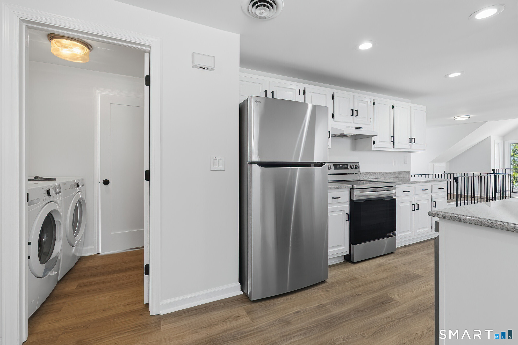 426 Main Street, Unit G Ridgefield, CT 06877 - Photo 5 of 24 a kitchen with refrigerator a washer and dryer