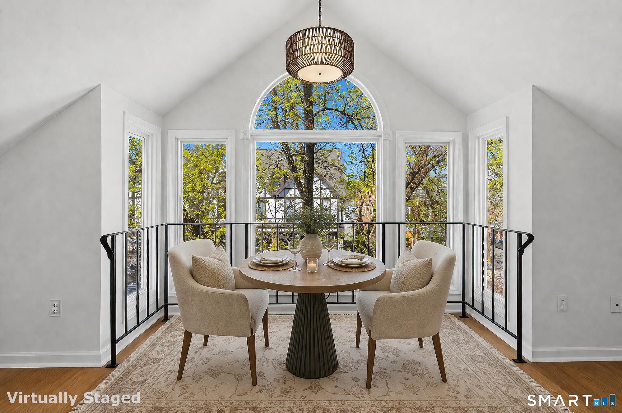 426 Main Street, Unit G Ridgefield, CT 06877 - Photo 10 of 24 a dining room with furniture a chandelier and wooden floor