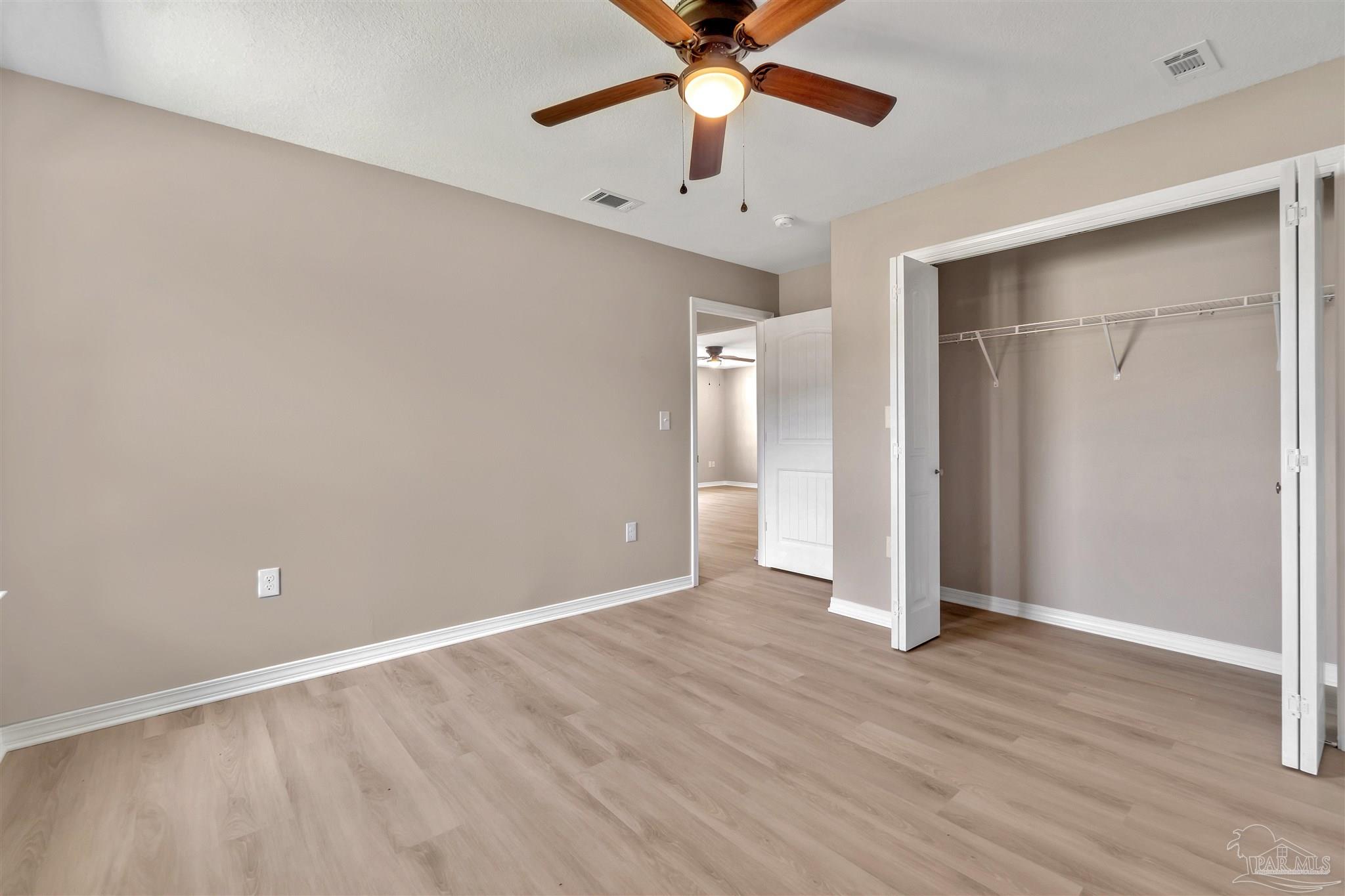 50 Fulton Avenue Pensacola, FL 32503 - Photo 12 of 22 wooden floor in an empty room with a window