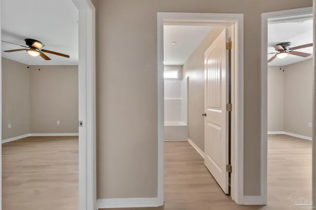 a view of a hallway with wooden floor
