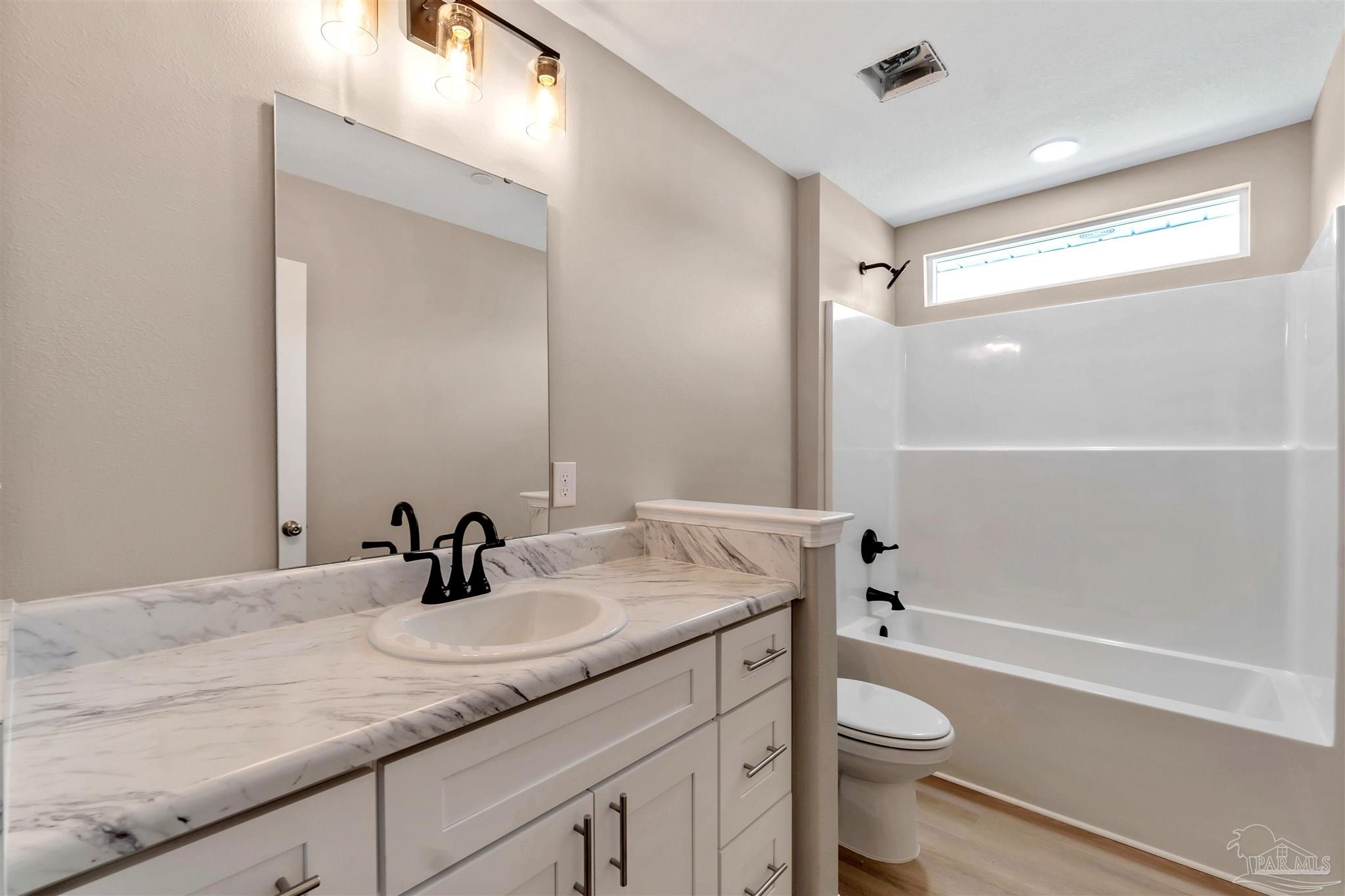 50 Fulton Avenue Pensacola, FL 32503 - Photo 14 of 22 a bathroom with a sink a toilet and shower