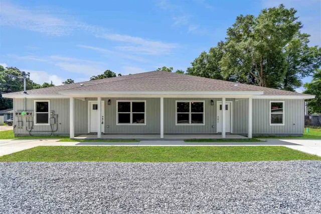 a front view of a house with a yard and a garage