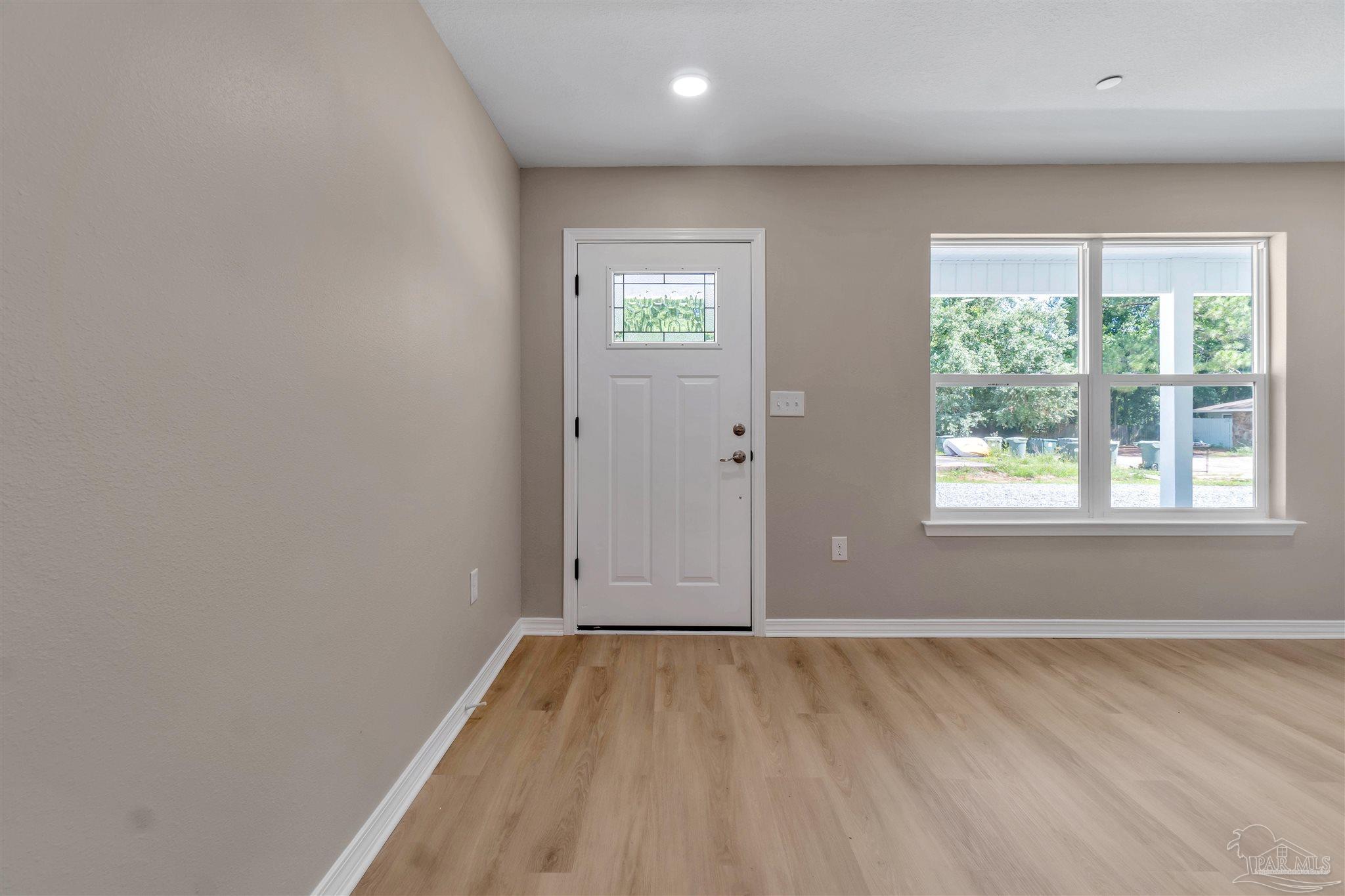 50 Fulton Avenue Pensacola, FL 32503 - Photo 3 of 22 an empty room with wooden floor and windows