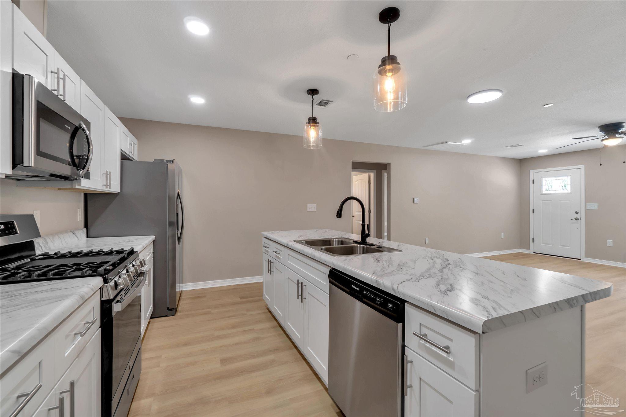 50 Fulton Avenue Pensacola, FL 32503 - Photo 8 of 22 a kitchen with granite countertop a sink stainless steel appliances and cabinets