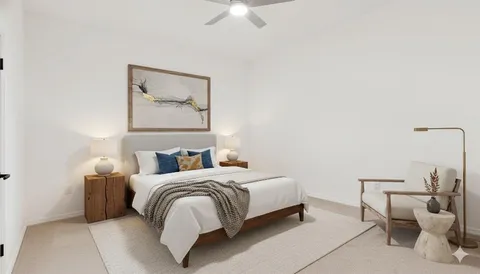 an empty room with a ceiling fan and windows