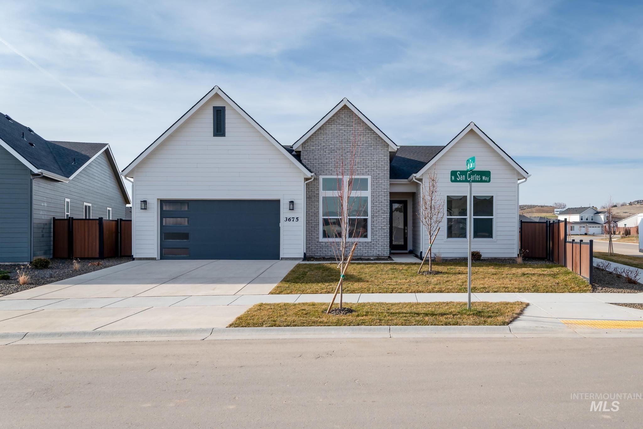 5318 Sparky Avenue Caldwell, ID 83607 - Photo 1 of 11 View of front of home with driveway, brick siding, and a garage
