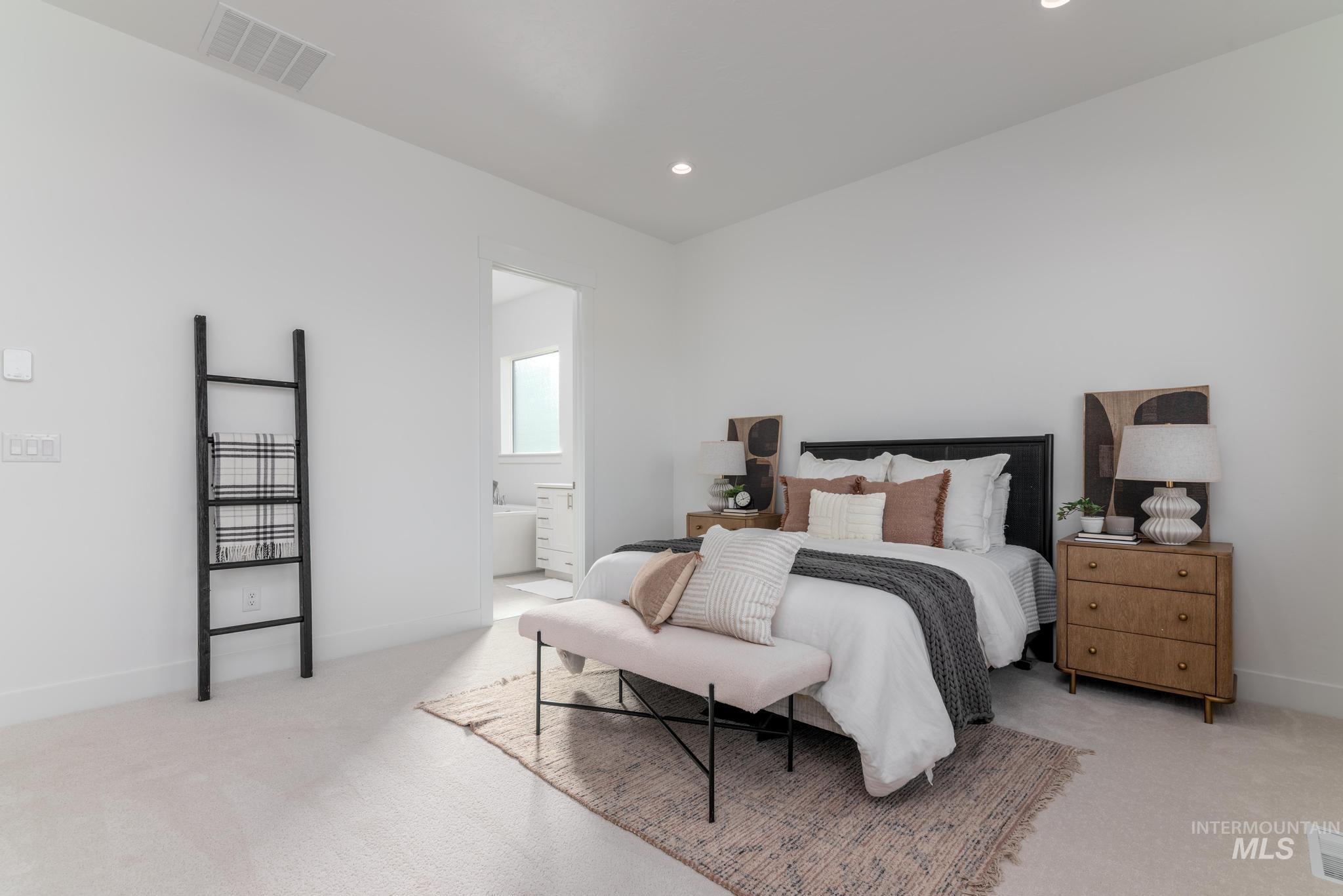 5318 Sparky Avenue Caldwell, ID 83607 - Photo 6 of 11 Bedroom with light colored carpet, recessed lighting, and connected bathroom