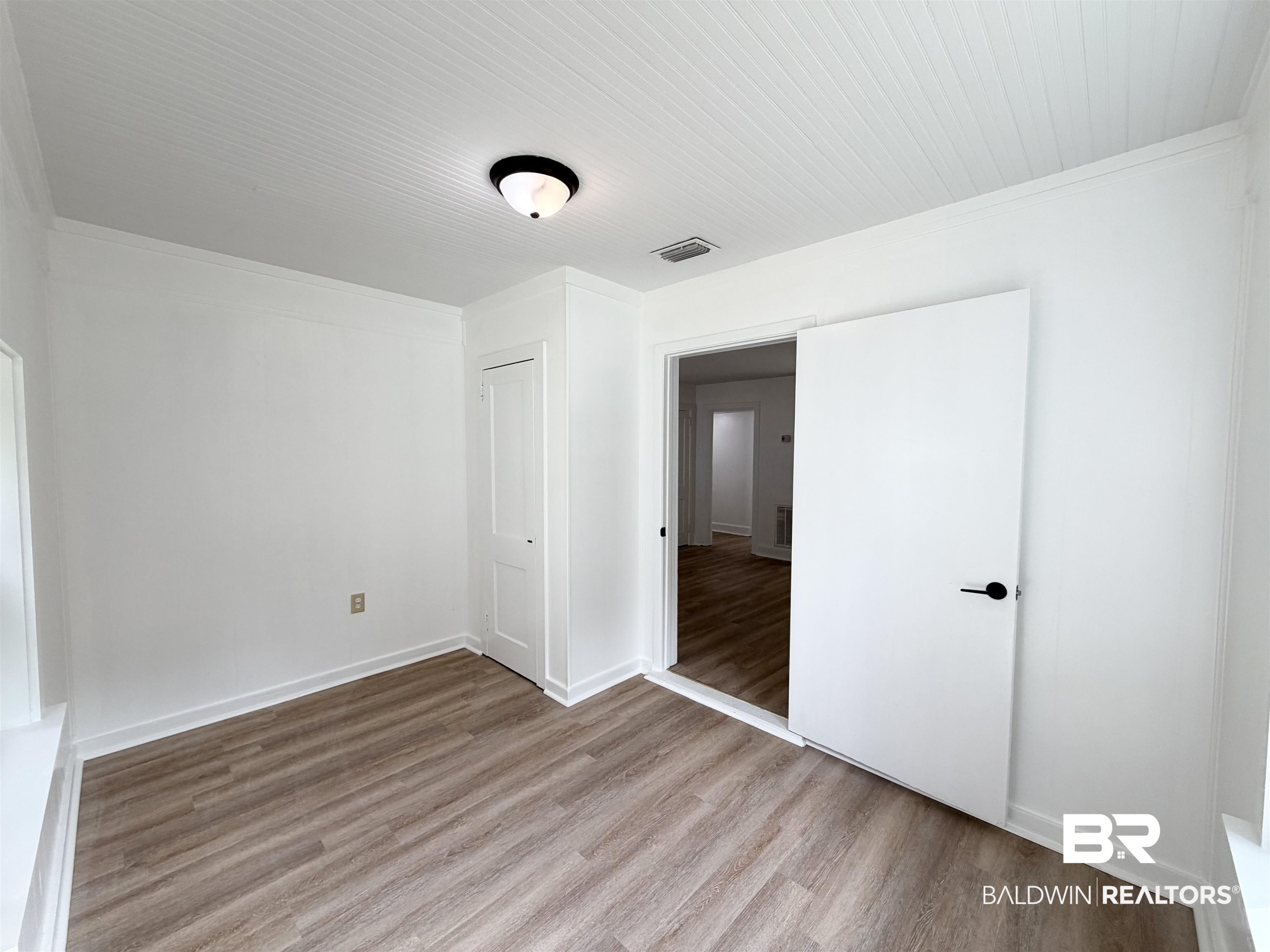 606 Shady Oak Drive Mobile, AL 36608 - Photo 12 of 14 Unfurnished bedroom featuring light wood finished floors and ornamental molding