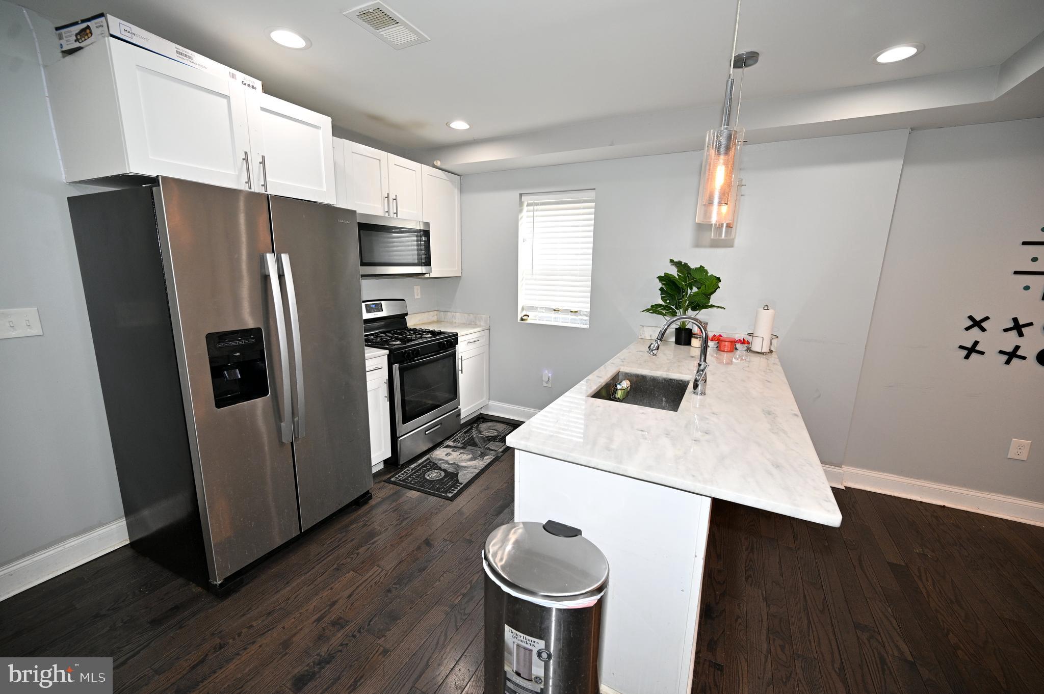 3700 Flowerton Road Baltimore, MD 21229 - Photo 13 of 30 a kitchen with sink a refrigerator and microwave