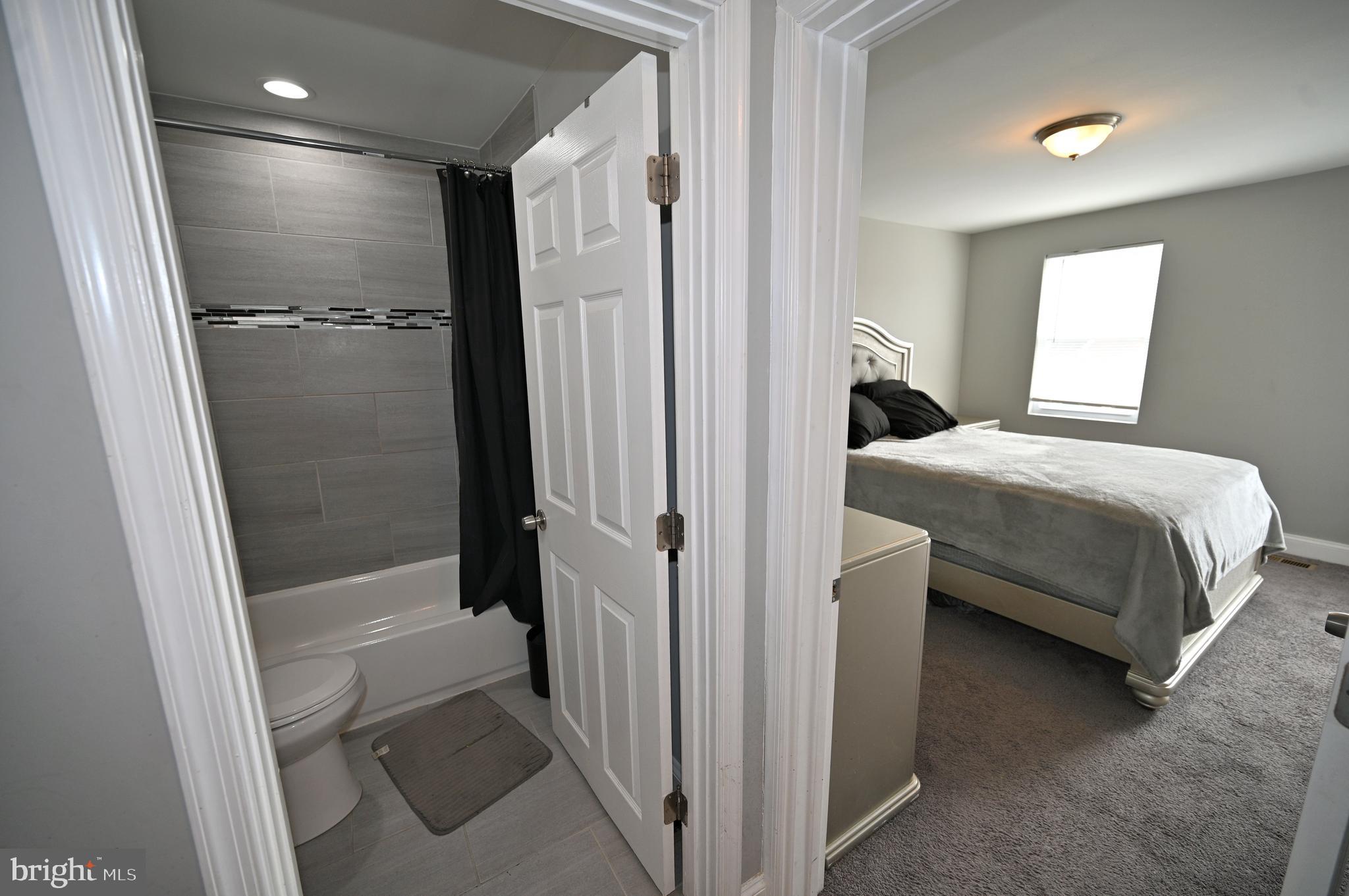 3700 Flowerton Road Baltimore, MD 21229 - Photo 19 of 30 a bathroom with a bathtub and a shower