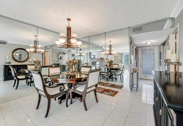 a kitchen with stainless steel appliances granite countertop a stove a sink and white cabinets