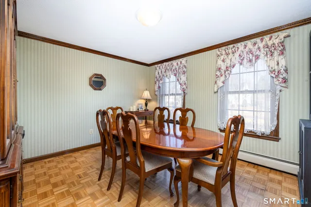 a dining room with furniture and wooden floor