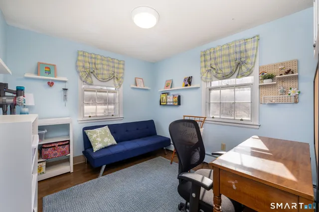 a bedroom with furniture and a window