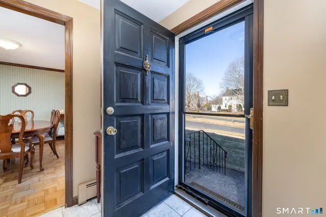 a view of a hallway and a livingroom with furniture