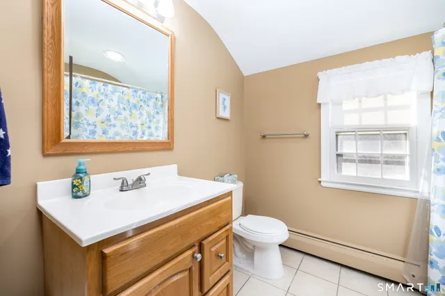 a bedroom with furniture and a flat screen tv