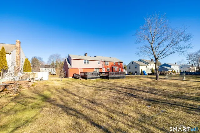 a view of a roof deck with couches and wooden floor