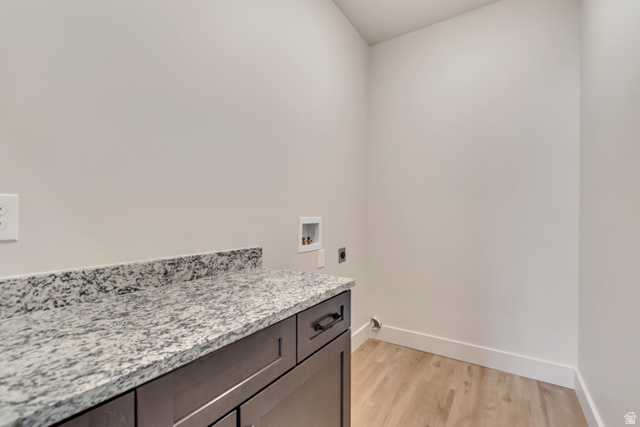 2535 West Santa Fe Drive Mapleton, UT 84664 - Photo 22 of 26 Laundry area with light wood-type flooring, hookup for an electric dryer, washer hookup, and cabinet space