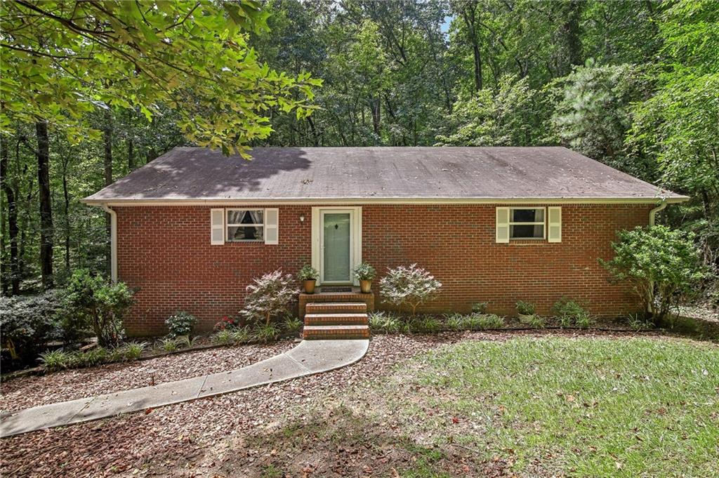 107 Indian Forest Road Jasper, GA 30143 - Photo 1 of 1 a front view of a house with garden
