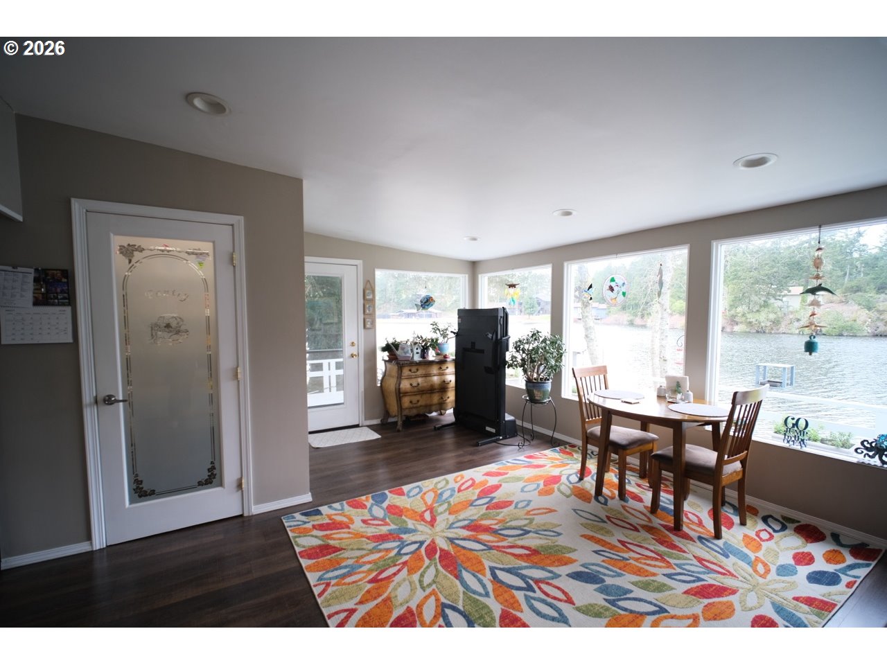 70214 Lakewood Road North Bend, OR 97459 - Photo 2 of 39 a living room with furniture a dining table and a large window
