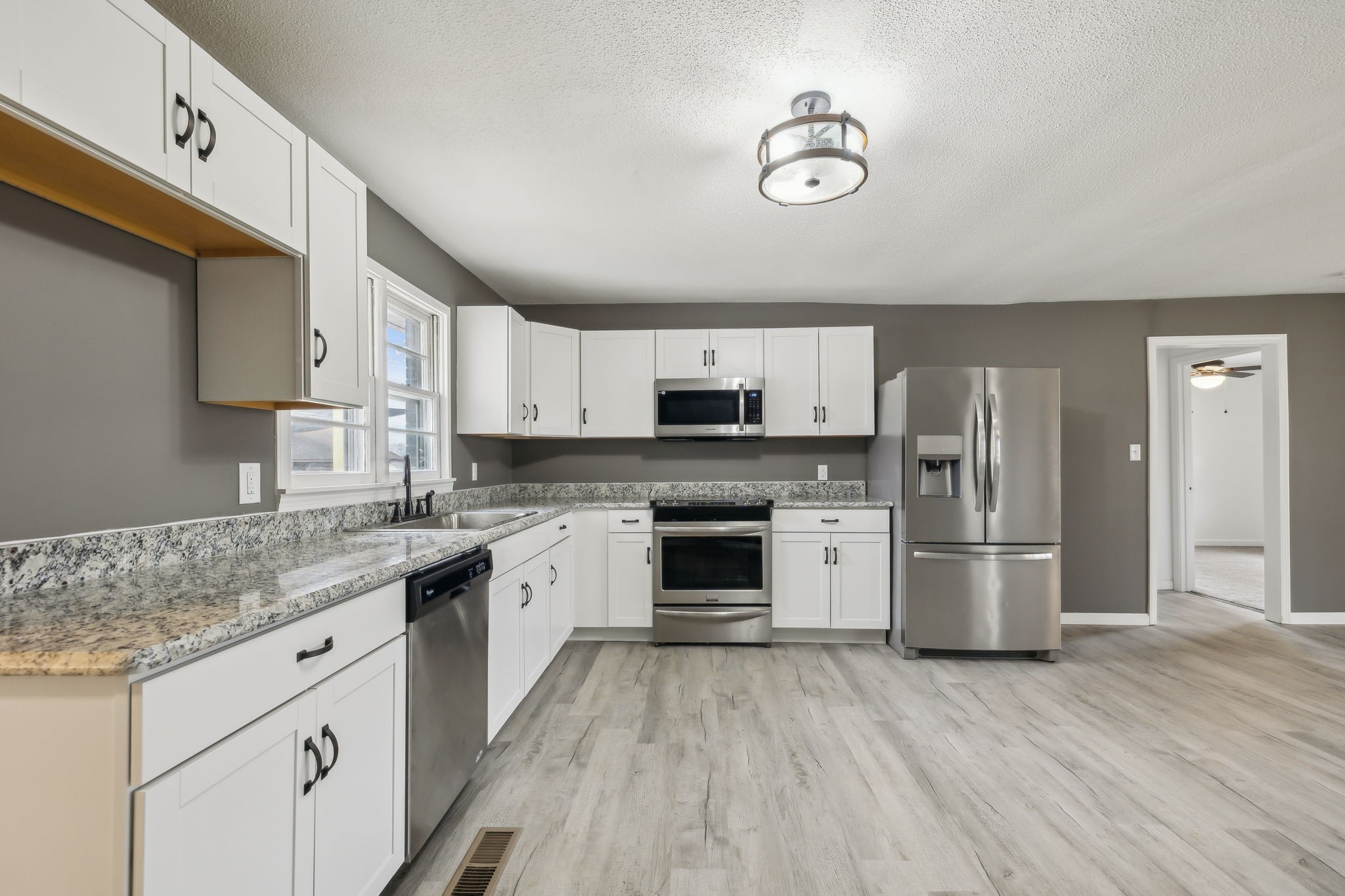 502 Browns Road Lafayette, TN 37083 - Photo 11 of 50 a kitchen with a stove a sink and a refrigerator