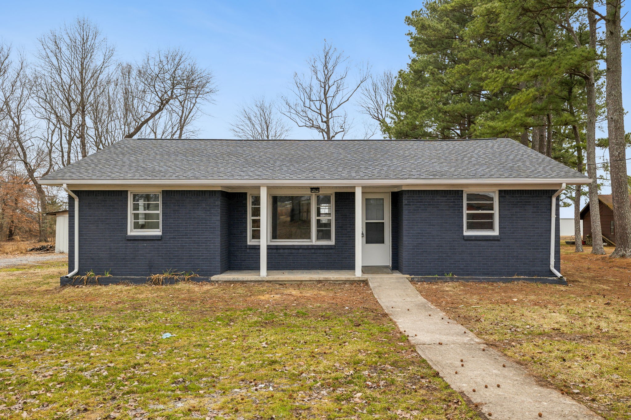 502 Browns Road Lafayette, TN 37083 - Photo 3 of 50 a front view of a house with yard and trees in the background