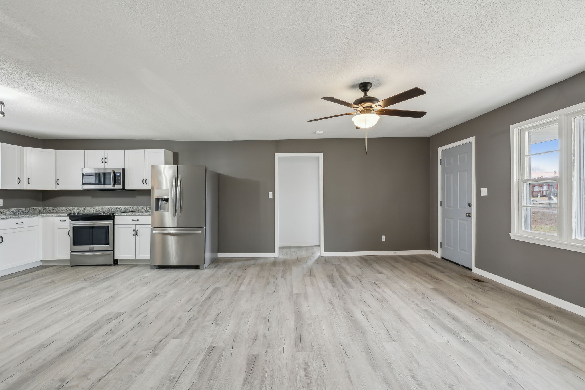 502 Browns Road Lafayette, TN 37083 - Photo 9 of 50 a view of an empty room with kitchen and a window