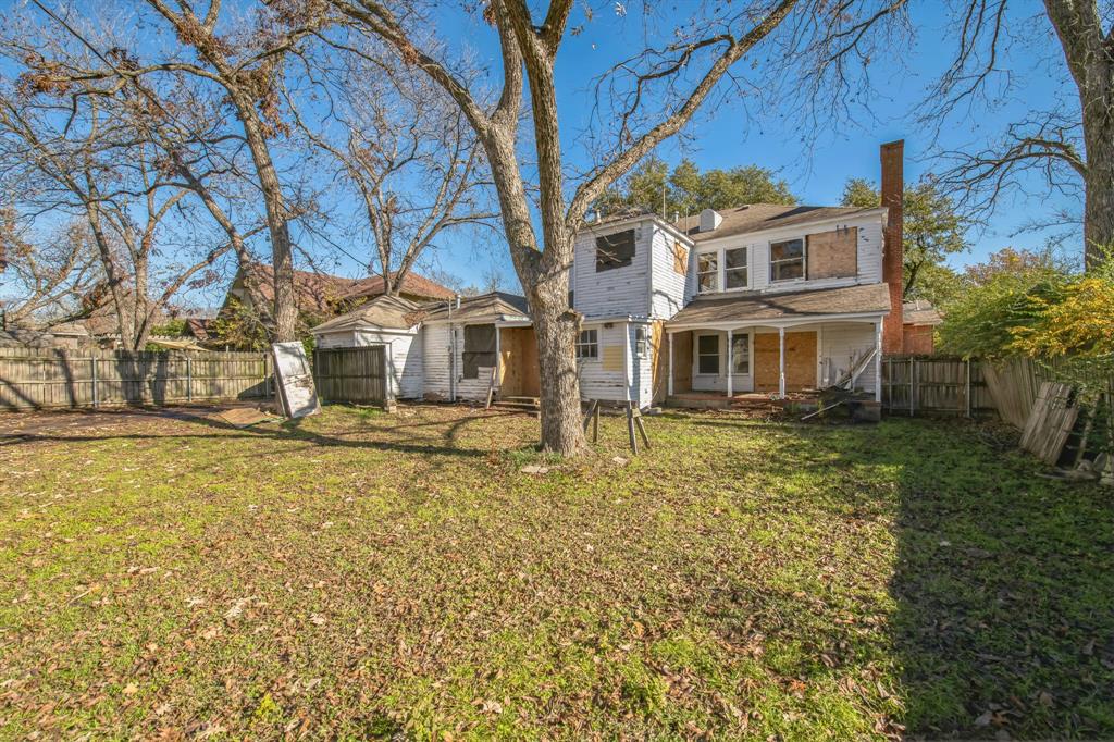 404 Forrest Avenue Cleburne, TX 76033 - Photo 23 of 27 Rear view of house featuring a lawn