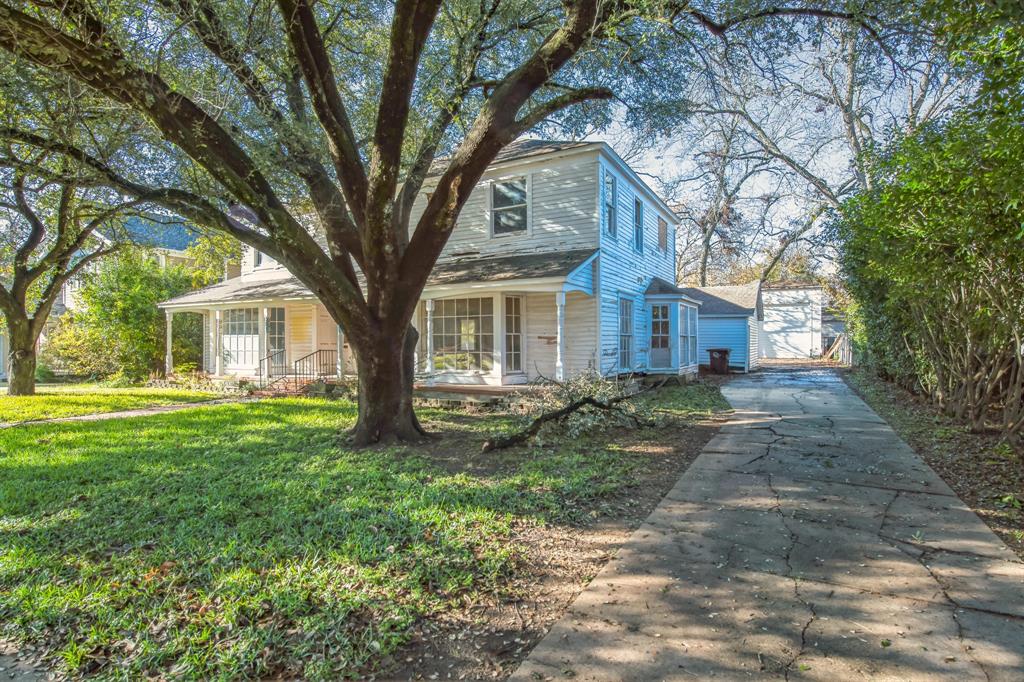 404 Forrest Avenue Cleburne, TX 76033 - Photo 3 of 27 View of front of home with covered porch, an outbuilding, and a front lawn