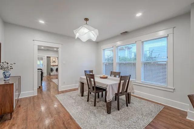 a view of a dining room with furniture wooden floor and chandelier