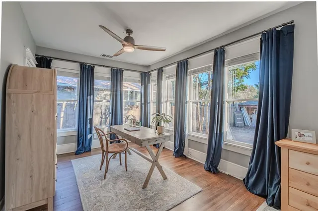 a dining room with wooden floor and a glass door