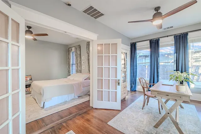 a spacious bedroom with a bed and a table