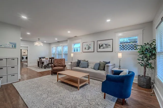 a living room with furniture and a potted plant
