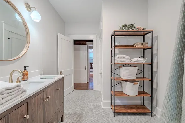 a spacious bathroom with a sink a mirror and shower