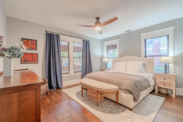 a bedroom with a large bed and a flat tv screen on dresser