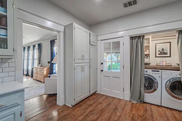 a view of a hallway with washer and dryer