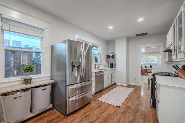 a kitchen with stainless steel appliances a refrigerator sink and stove