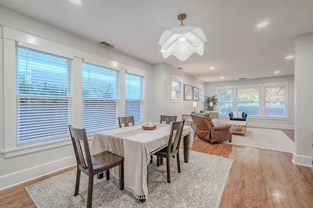 a view of a dining room with furniture window and wooden floor