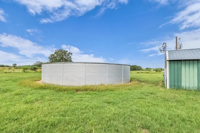 an aerial view of a house with garden space and sitting area