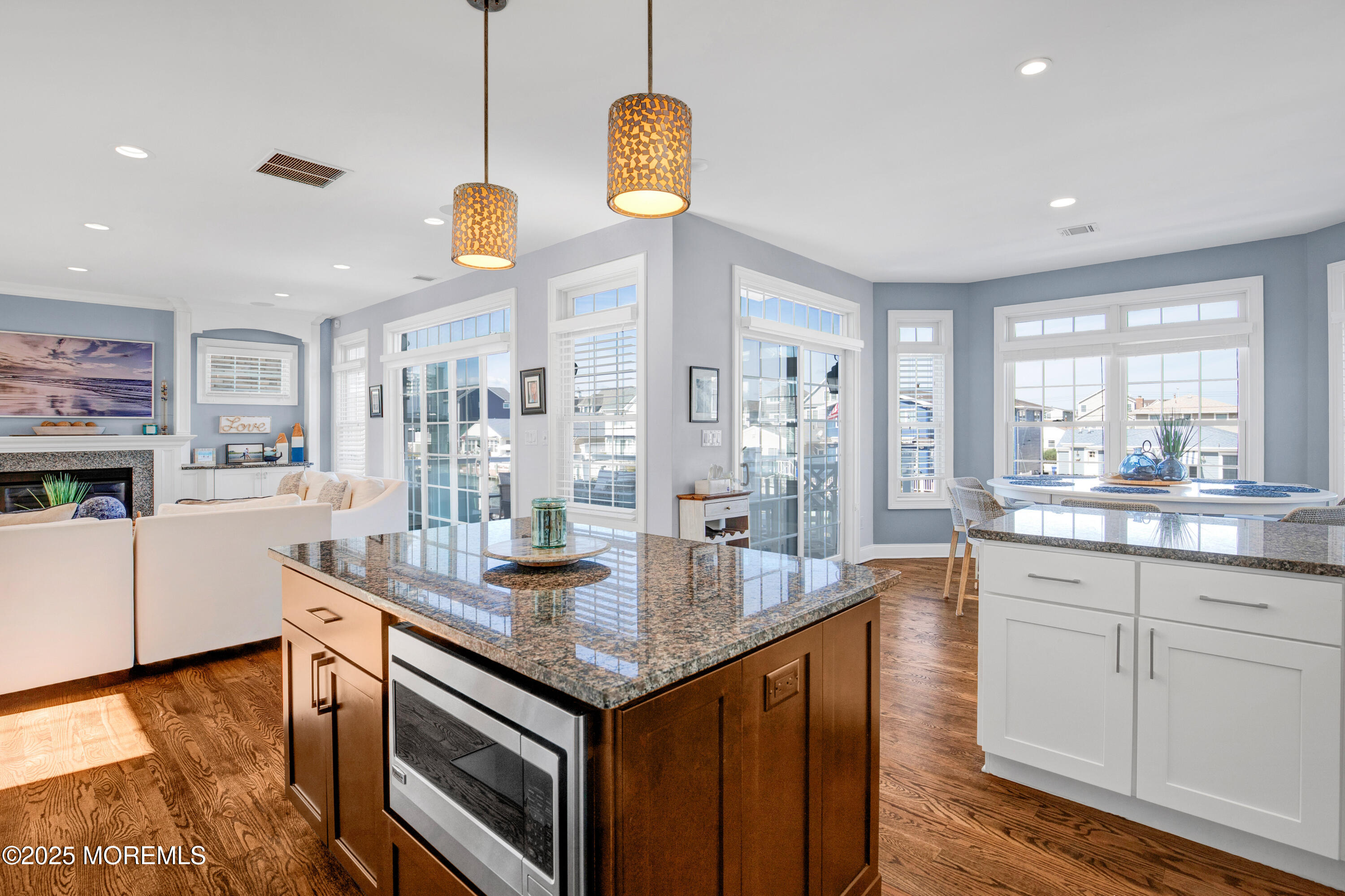 206 North Lagoon Road, Unit SUMMER 2026 Lavallette, NJ 08735 - Photo 11 of 50 a kitchen with granite countertop white cabinets and chandelier