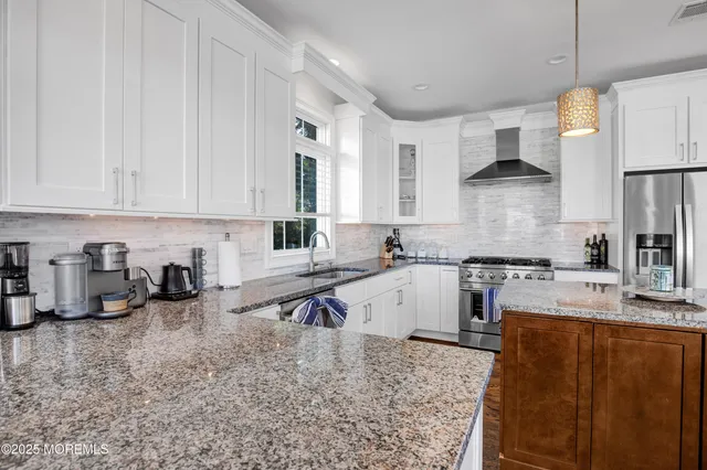 a kitchen with a sink a stove and cabinets