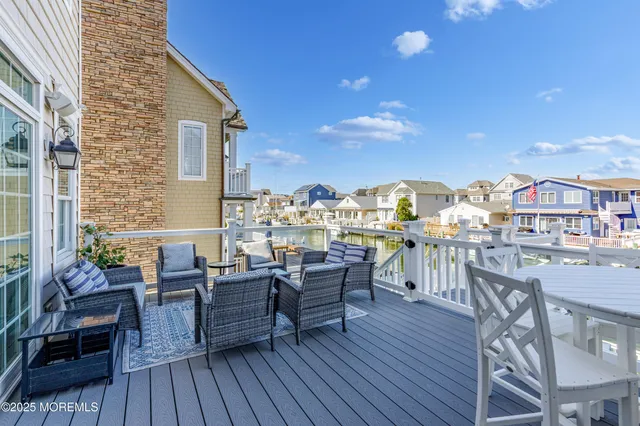 a view of a rooftop deck and patio with chairs