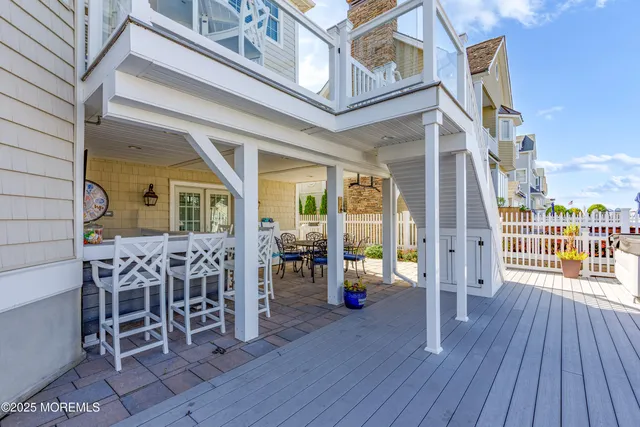 a view of a patio with a table and chairs and wooden floor